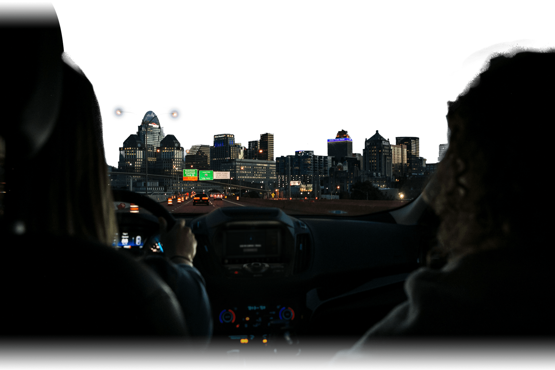 a view of driving into a city center from within a vehicle at night